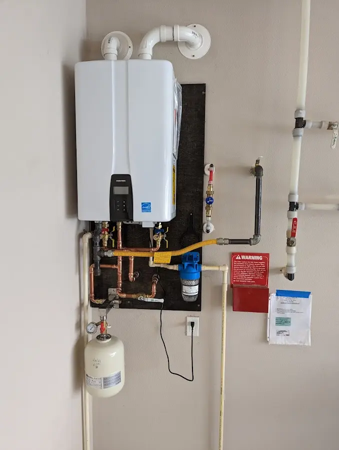 Professional plumber installing copper piping in a The Pinery home